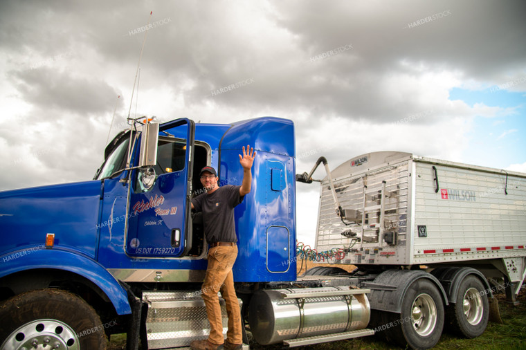 Farmer Climbing into Semi Cab and Waving 25540