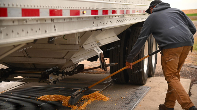 Farmer Sweeping Corn into On-farm Storage Grain Pit 25661