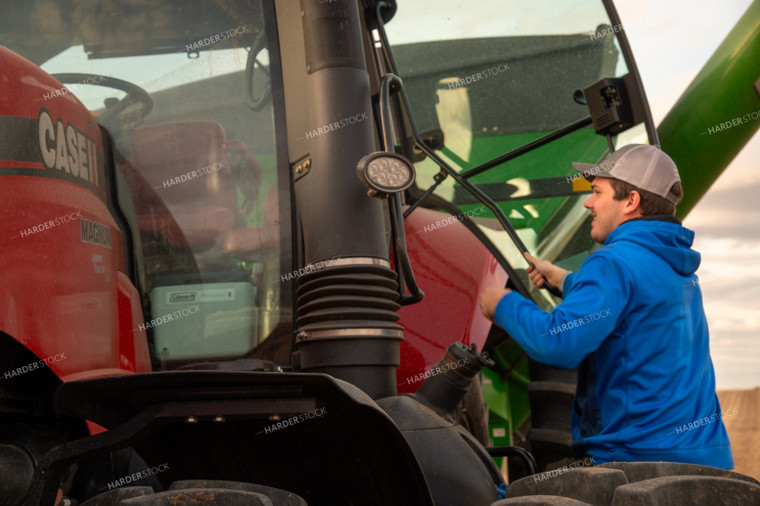 Farmer Climbing into Tractor Cab 25685