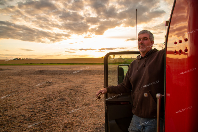 Farmer Watching Harvest from Semi Cab 25696