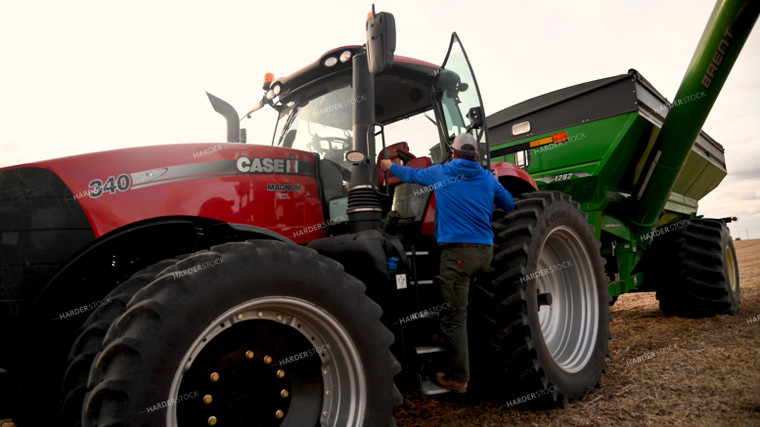 Farmer Climbing into Tractor Cab 25718