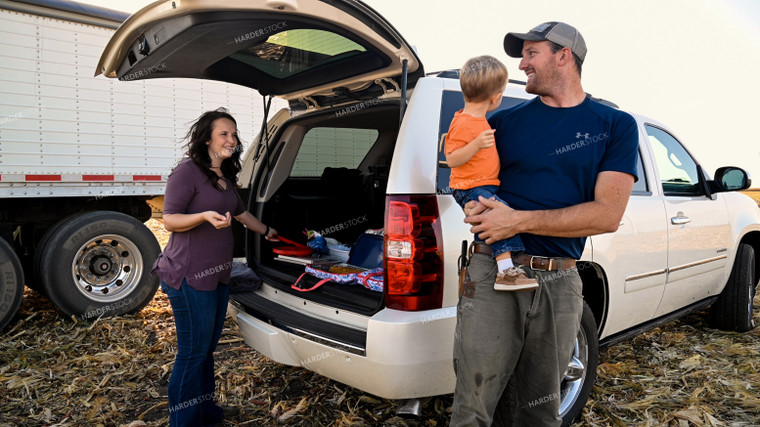 Family Enjoying Harvest Meal in the Field 25775