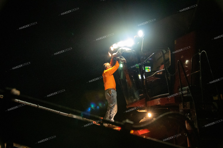 Farmer Sitting in Combine at Night 25805