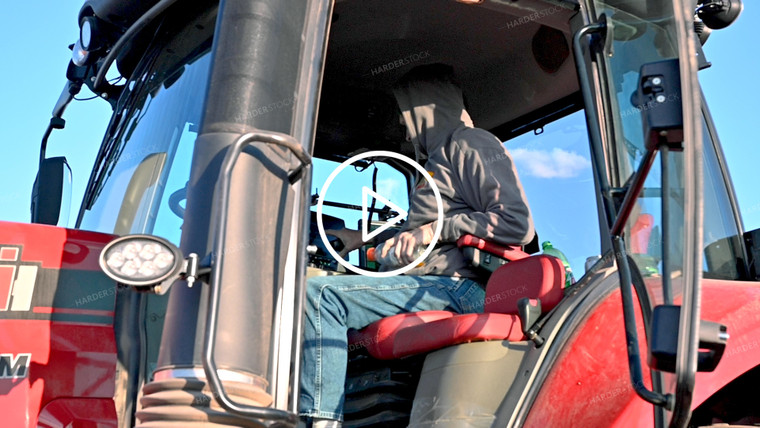 Farmer Talking on Radio in Tractor Cab - 039
