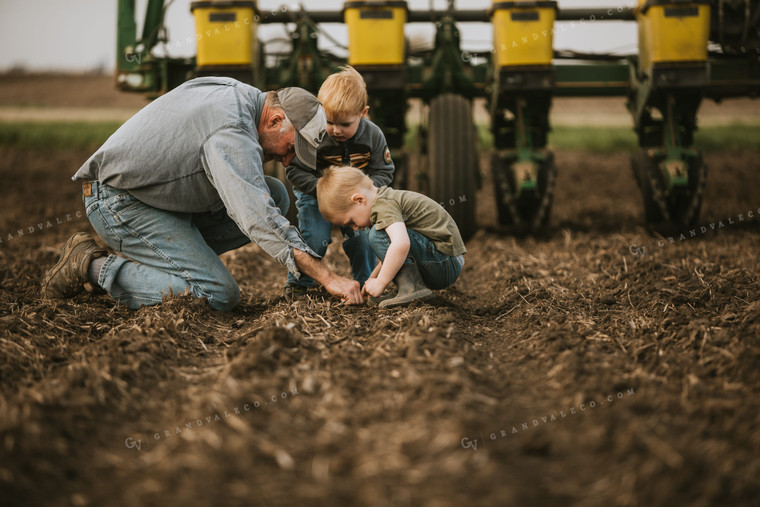 Farmer Checking Seed Depth with Farm Kids 5486