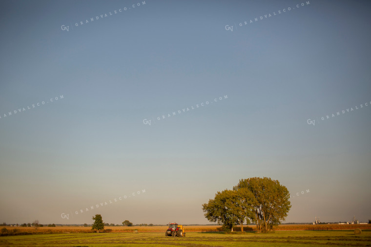 Tractor Baling Hay with Blue Sky Background 5506