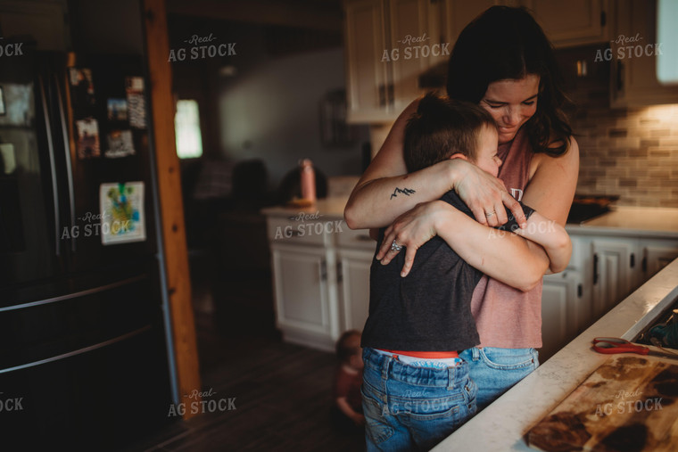 Farm Mom and Farm Kid Hugging in Kitchen 5590