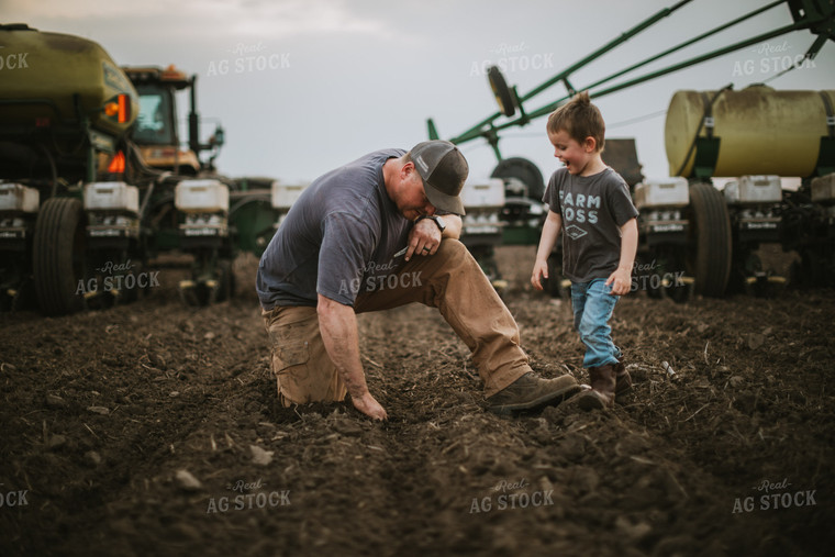 Farmer and Farm Kid Checking Seed Depth 5651