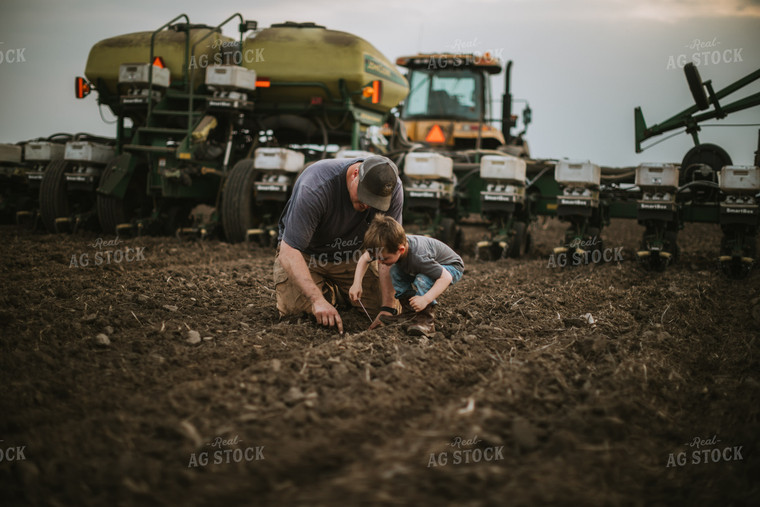 Farmer and Farm Kid Checking Seed Depth 5653