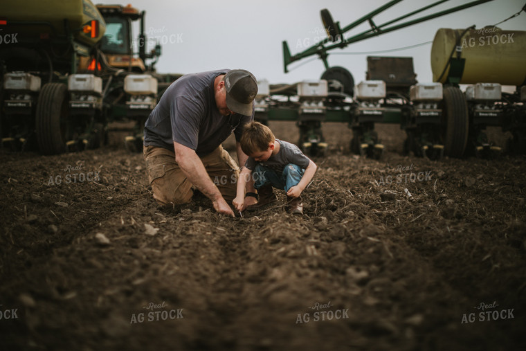 Farmer and Farm Kid Checking Seed Depth 5654