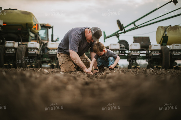 Farmer and Farm Kid Checking Seed Depth 5655