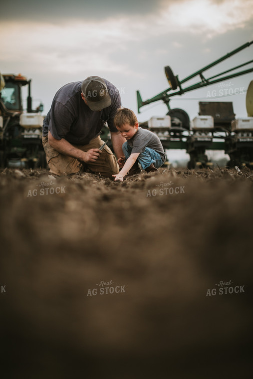 Farmer and Farm Kid Checking Seed Depth 5657