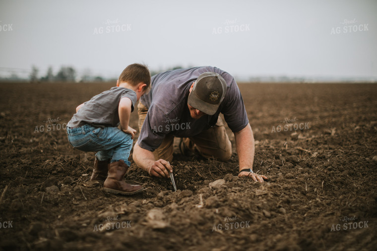 Farmer and Farm Kid Checking Seed Depth 5661