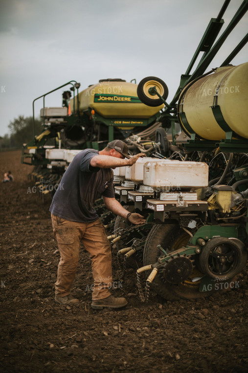 Farmer Adjusting Planter 5692