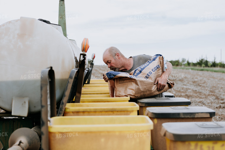 Farmer Filling Planter Boxes 77070