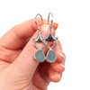 Aqua Sea Glass Bit Earrings on model for color reference.