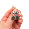 Olive Sea Glass Bit Earrings on model for color reference.