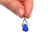 Cobalt Bright Sea Glass Lunar Drop Charm held to the light