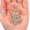 Aqua and Yellow Honeysuckle Sea Glass Flower Necklace in hand for color reference