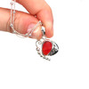 Red Fire Ultra Rare Sea Glass Mariposa Necklace held to the light