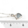 Gray Sea Glass Wave Necklace on ruler for size reference. 
