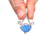 Blue Arctic Blast Ultra Rare Sea Glass Tidal Drop Necklace held to the light