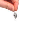 Sterling Silver Leaf Charm held to the light