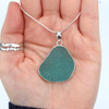 Aqua Tropical Sea Glass Single Bezel Set Necklace in hand for color reference