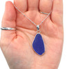 Cobalt Sea Glass Sail Bezel Necklace in hand for color reference