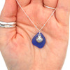 Cobalt Sea Glass and Lita Shell Charm Necklace in hand for color reference