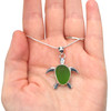 Turtle Sea Glass Necklace displayed on palm for details 