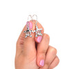 Sterling Silver Tiny Turtle Earring on model for color reference. 
