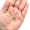 Seafoam Drop Scallop Shell Sea Glass Necklace on model's palm for color and details