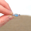 Cornflower Clouds Ultra Rare Sea Glass and Pink Sapphire Sterling Silver Nova Ring held to the light