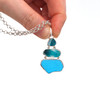 Turquoise Embossed and Spotted Ultra Rare Sea Glass Three Tier Necklace held to the light for color detail