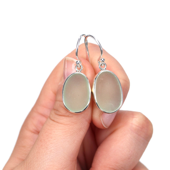 Seafoam Oval Sea Glass Single Bezel Earrings on model for color reference.
