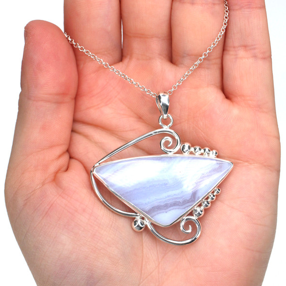 Lace Agate Whirlwind Necklace on model for color reference.