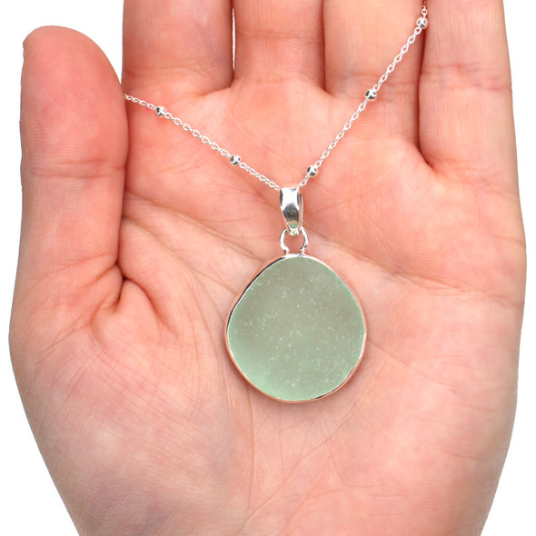 Seafoam Round Sea Glass Single Bezel Necklace on model for color reference.