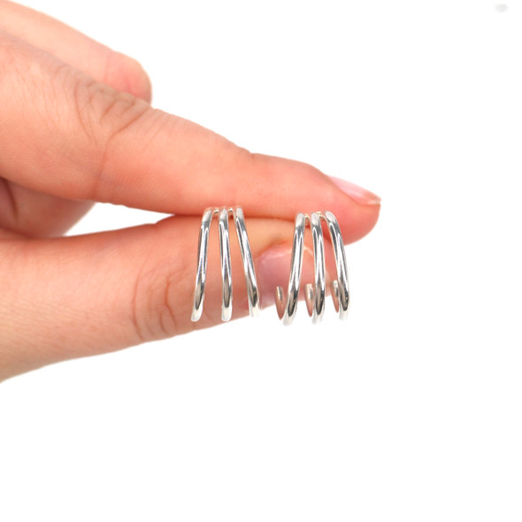 Triple Cuff Sterling Silver Earrings - Medium Size held to the light