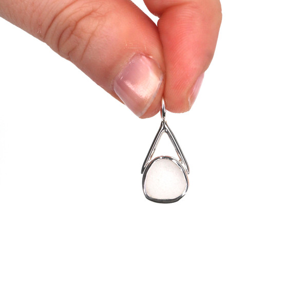 White Sea Glass Lunar Drop Charm held to the light