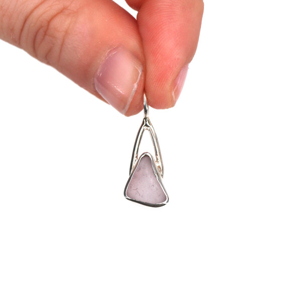 Lavender Triangle Sea Glass Lunar Drop Charm held to the light