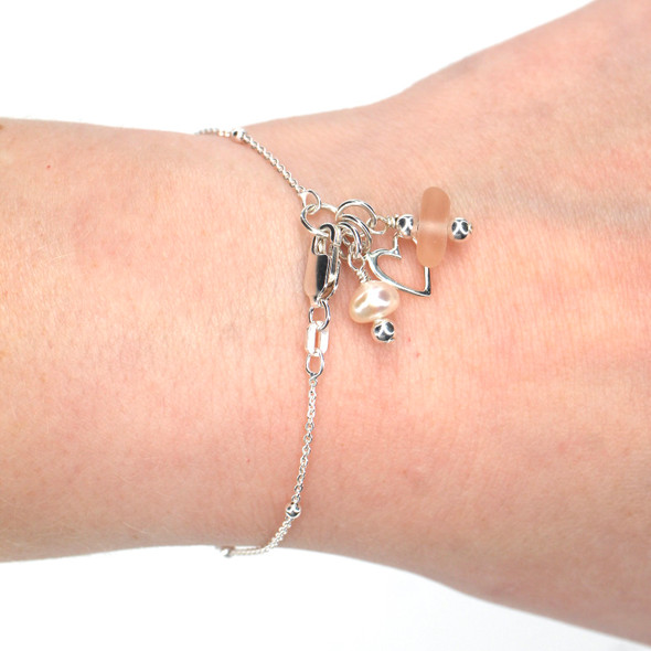 Pink Sea Glass and Pearl Heart Charm Bracelet on model for color reference. 