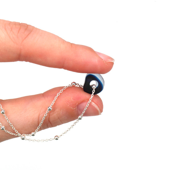 Turquoise Ocean Spot Ultra Rare Sea Glass Simple Necklace held to the light