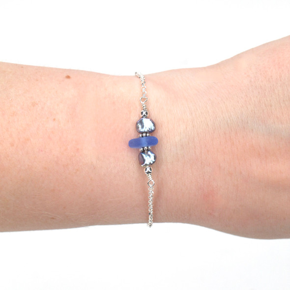 Cornflower Smooth Sea Glass and Dainty Peacock Pearl Bracelet on model for color reference.