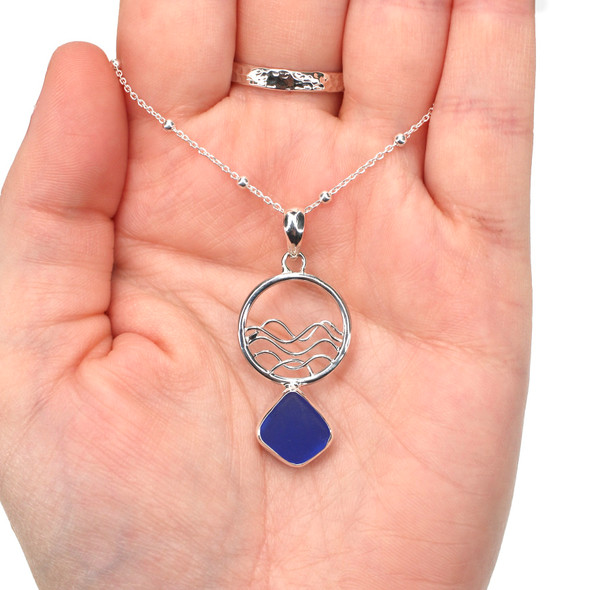 Cobalt Sea Glass Ocean Wave Necklace on model for color reference.