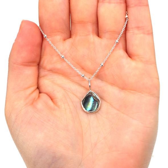 Abalone Gumdrop Charm on model for color reference.