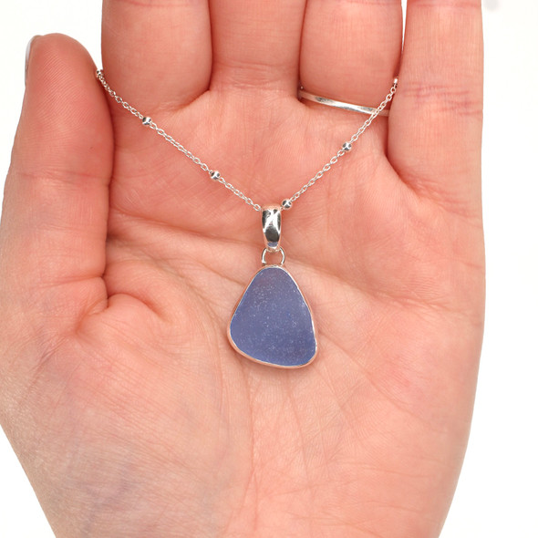 Cornflower Smooth Triangle Drop Sea Glass Bezel Set Necklace on model for color reference. 