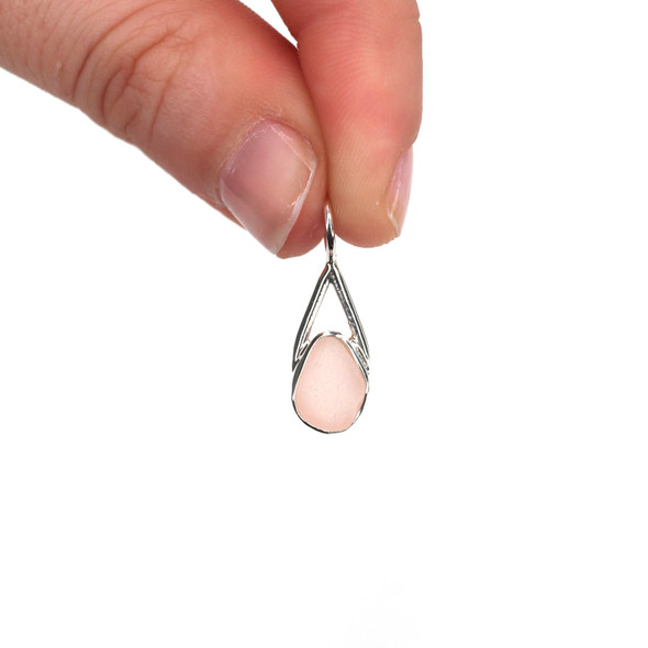 Pink Sea Glass Lunar Drop Charm held to the light