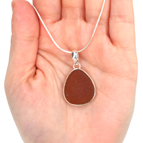 Amber Smooth Drop Sea Glass Single Bezel Necklace on model for color reference.
