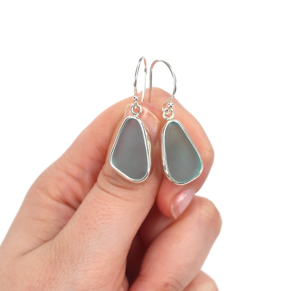 Aqua Ice Elongated Sea Glass Single Bezel Earrings on model for color reference.